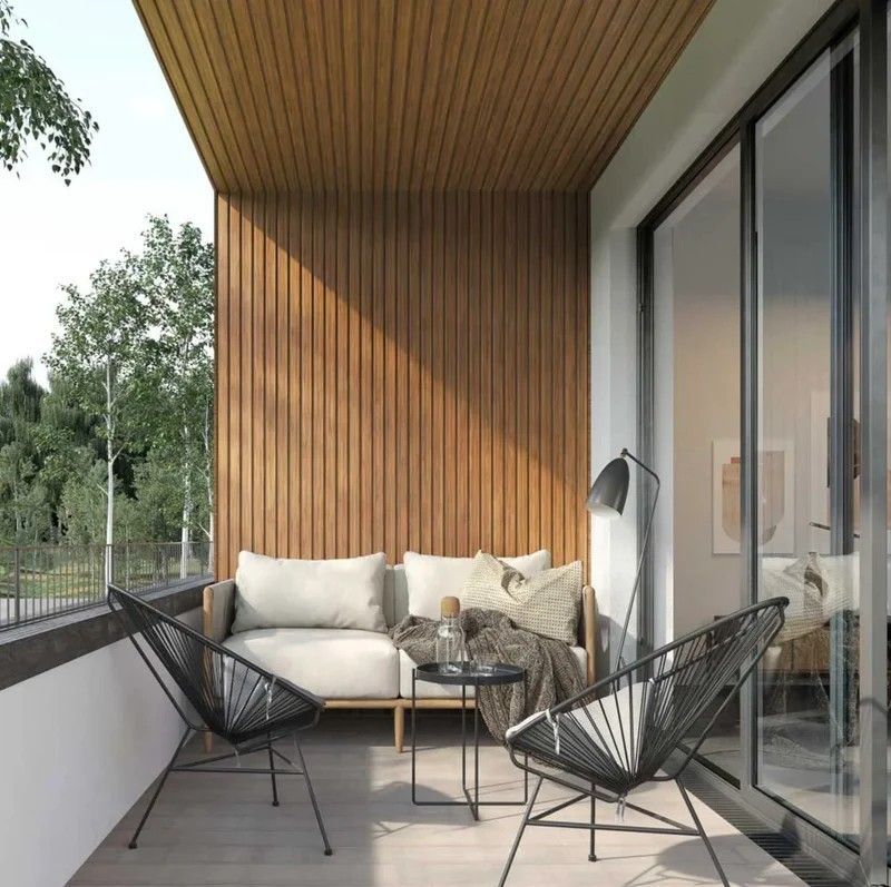 Compact urban balcony with vertical wood slat feature wall and matching WPC soffit ceiling